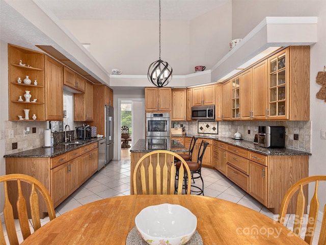 kitchen with open shelves, decorative backsplash, a sink, appliances with stainless steel finishes, and an inviting chandelier