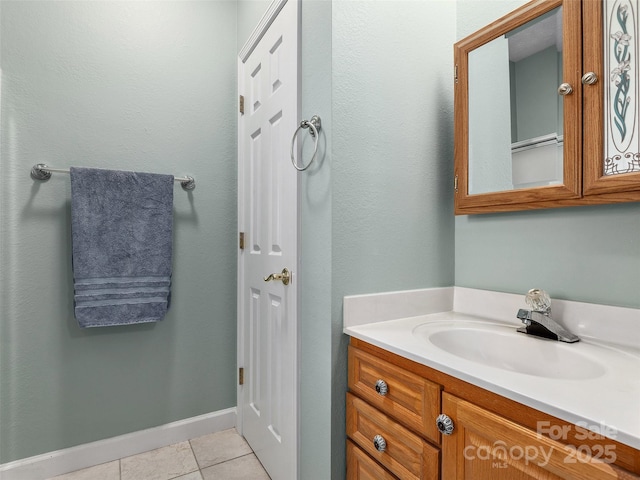 bathroom featuring tile patterned floors, baseboards, and vanity