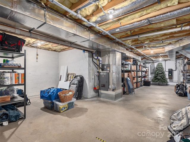 unfinished basement featuring heating unit
