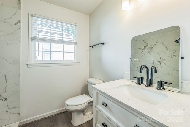 full bath with wood finished floors, vanity, walk in shower, baseboards, and toilet
