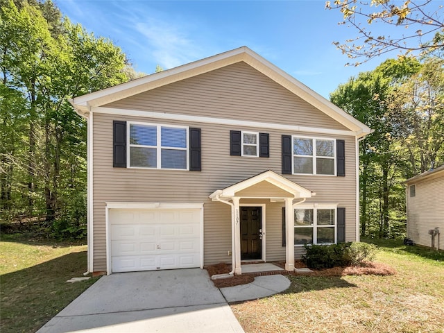traditional home featuring an attached garage, concrete driveway, and a front lawn