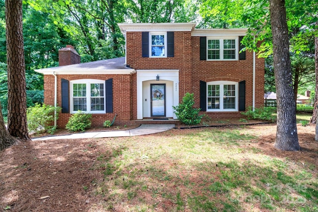 8807 Tree Haven Dr, Charlotte, NC 28270 - view of front facade with brick siding, a chimney, and a front lawn
