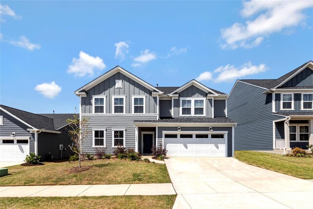 14224 Canemeadow Dr, Charlotte, NC 28278 - view of front of home featuring board and batten siding, driveway, a front lawn, and an attached garage