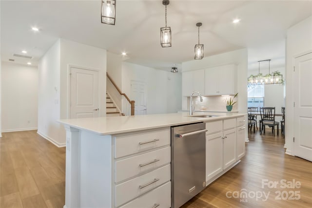 14224 Canemeadow Dr, Charlotte, NC 28278 - kitchen with a sink, stainless steel dishwasher, light countertops, an island with sink, and recessed lighting