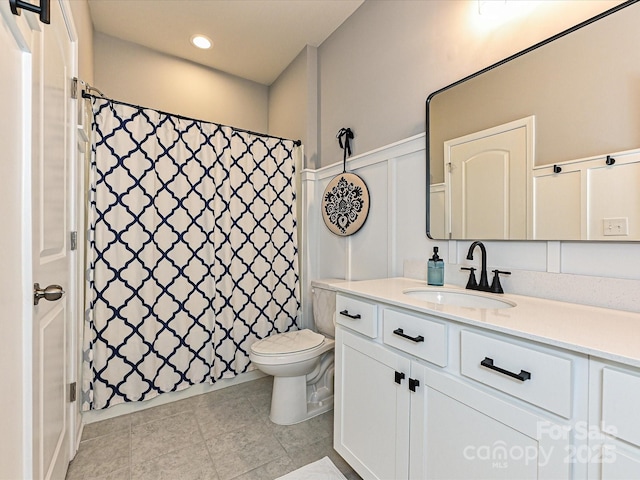 10035 Mast Cove Ln, Charlotte, NC 28278 - full bath featuring a decorative wall, toilet, vanity, tile patterned flooring, and wainscoting