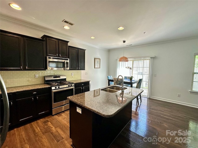 12421 Fiorentina St, Charlotte, NC 28277 - kitchen with ornamental molding, visible vents, appliances with stainless steel finishes, a sink, and backsplash