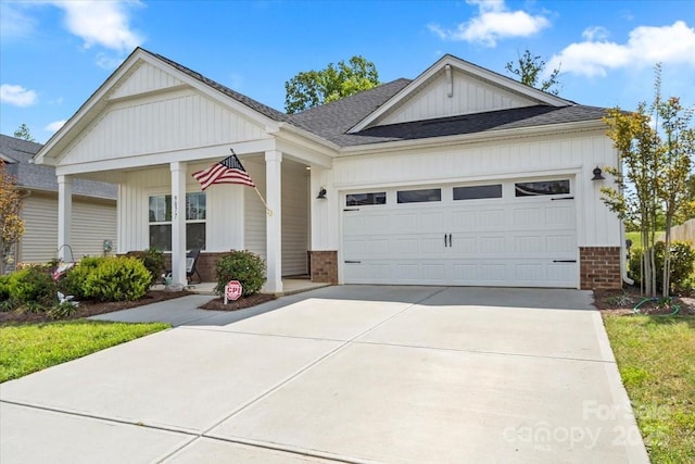 ranch-style home featuring driveway, board and batten siding, a porch, a garage, and brick siding