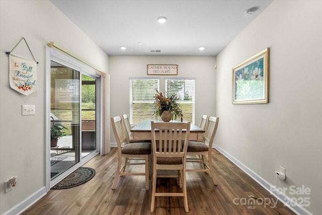 dining area featuring wood finished floors, a wealth of natural light, baseboards, and visible vents