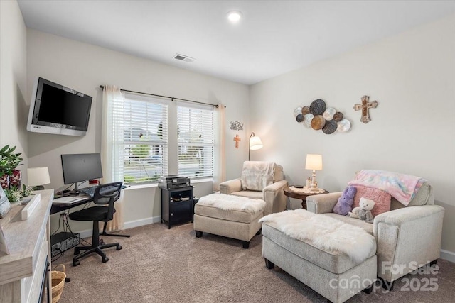 office space with baseboards, visible vents, and light colored carpet