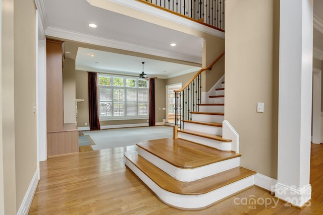 stairs featuring crown molding, recessed lighting, baseboards, and ceiling fan