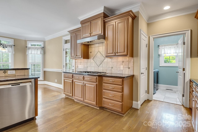 kitchen featuring gas cooktop, light wood finished floors, dishwasher, baseboards, and under cabinet range hood