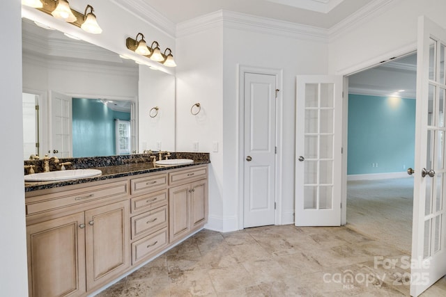 full bath featuring french doors, a sink, and ornamental molding