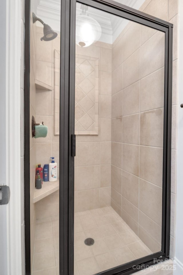 full bathroom featuring ornamental molding and a stall shower