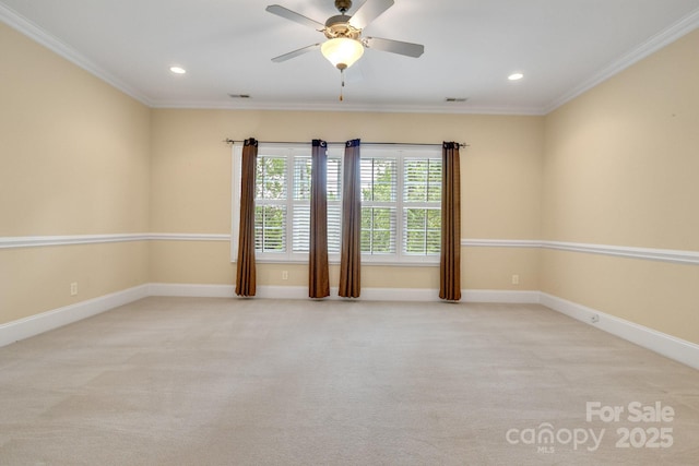 empty room with ornamental molding, ceiling fan, and carpet flooring