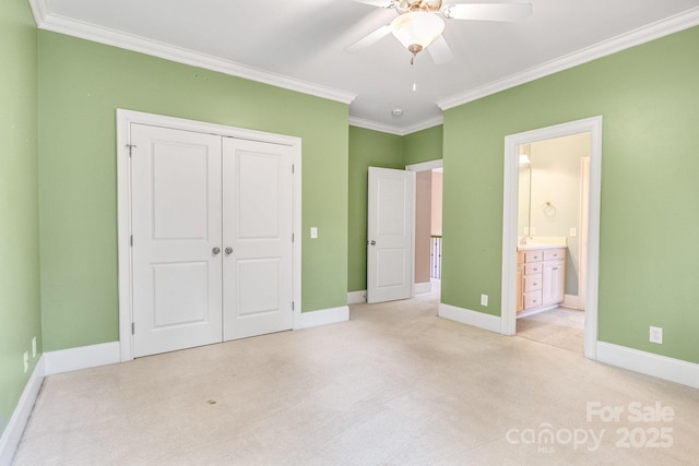 unfurnished bedroom with baseboards, light colored carpet, ornamental molding, and a closet