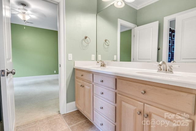 full bath with a sink, ornamental molding, a ceiling fan, and double vanity