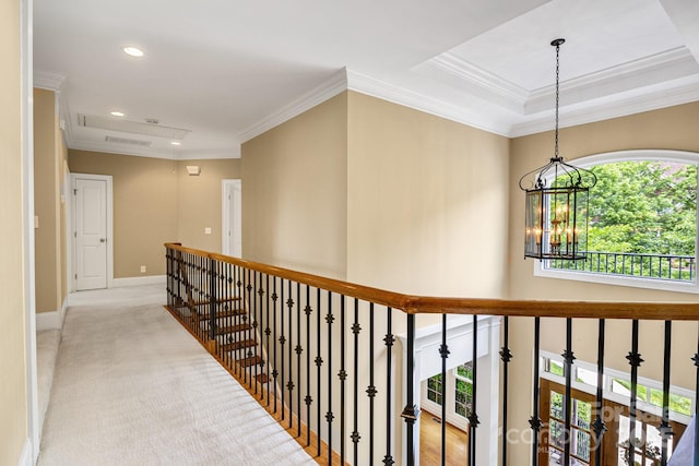 corridor featuring recessed lighting, ornamental molding, a wealth of natural light, and an inviting chandelier