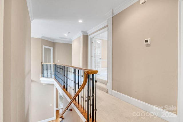 hallway featuring crown molding, baseboards, an upstairs landing, light carpet, and recessed lighting