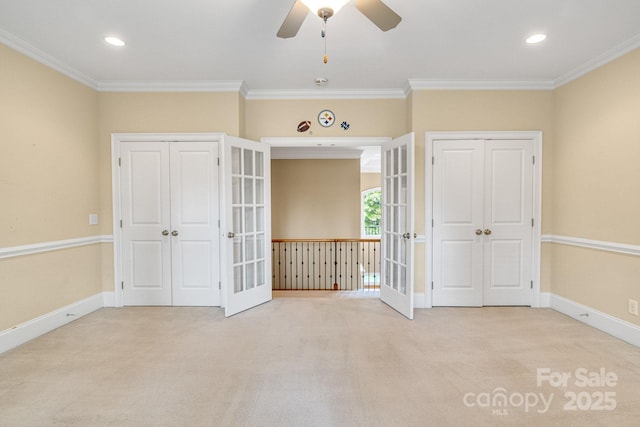 unfurnished bedroom featuring baseboards, ornamental molding, french doors, and carpet