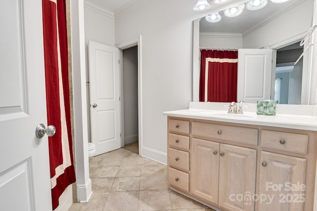 bathroom featuring crown molding, tile patterned flooring, vanity, toilet, and baseboards