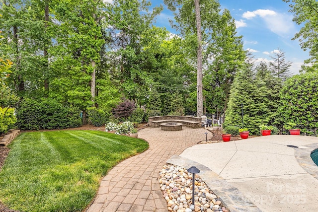 view of yard with a fire pit and a patio area