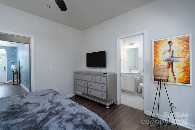 2932 Pirates Pl, Charlotte, NC 28216 - bedroom featuring dark wood-style floors, a sink, baseboards, ensuite bath, and a ceiling fan