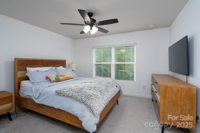 2932 Pirates Pl, Charlotte, NC 28216 - bedroom featuring light carpet, baseboards, and a ceiling fan