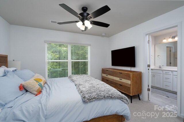 2932 Pirates Pl, Charlotte, NC 28216 - bedroom with light carpet, a ceiling fan, ensuite bathroom, and a sink