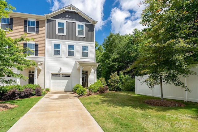 2932 Pirates Pl, Charlotte, NC 28216 - view of front of home with board and batten siding, an attached garage, driveway, and a front yard