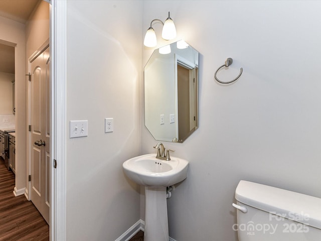 9134 Northfield Crossing Dr, Charlotte, NC 28269 - half bath with toilet, baseboards, and wood finished floors