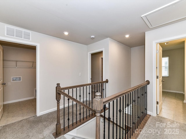 9134 Northfield Crossing Dr, Charlotte, NC 28269 - hallway featuring visible vents, attic access, tile patterned floors, and an upstairs landing
