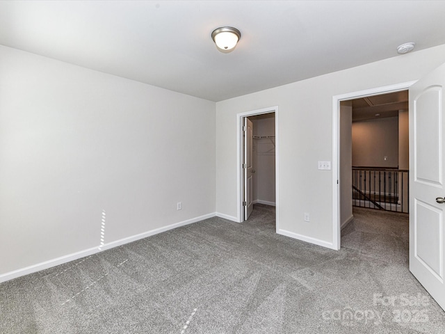 9134 Northfield Crossing Dr, Charlotte, NC 28269 - unfurnished bedroom featuring a walk in closet, attic access, carpet floors, baseboards, and a closet