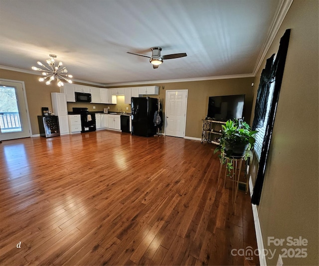 118 Knight Ln, Lawndale, NC 28090 - unfurnished living room with baseboards, dark wood-style floors, crown molding, ceiling fan with notable chandelier, and a sink