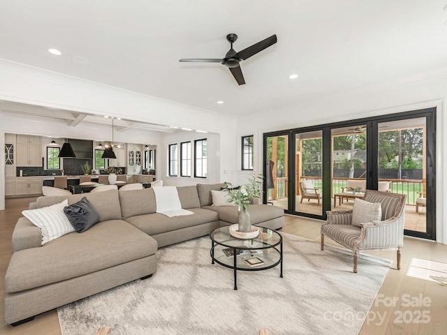 living area with ceiling fan, light wood-type flooring, ornamental molding, recessed lighting, and french doors