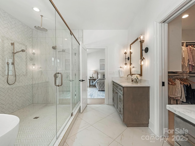 bathroom with recessed lighting, vanity, and a stall shower