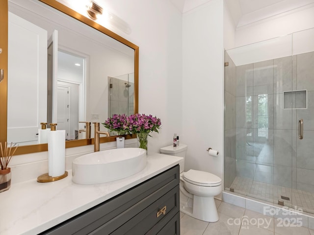 full bathroom featuring toilet, a stall shower, vanity, and tile patterned floors