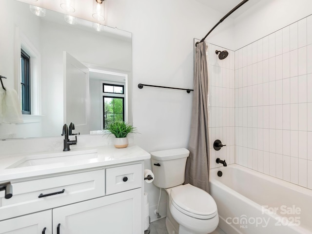 bathroom with shower / bath combo with shower curtain, vanity, and toilet