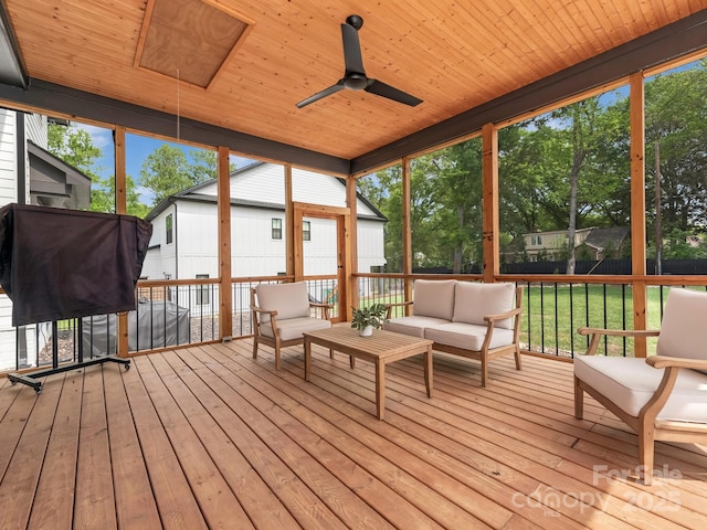 sunroom / solarium featuring ceiling fan and an outdoor hangout area