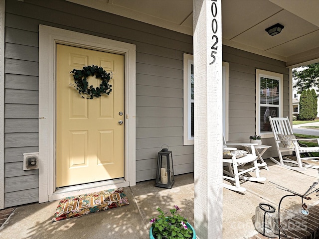 view of exterior entry featuring a porch