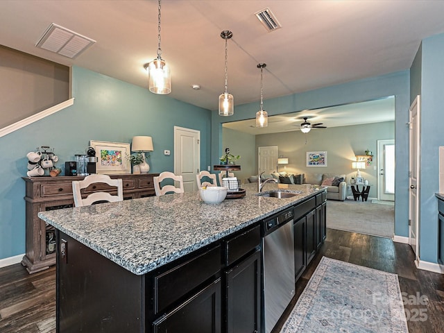kitchen with a sink, visible vents, open floor plan, and dishwasher