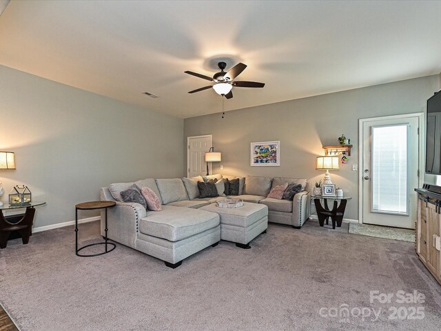 living area featuring visible vents, carpet floors, ceiling fan, and baseboards