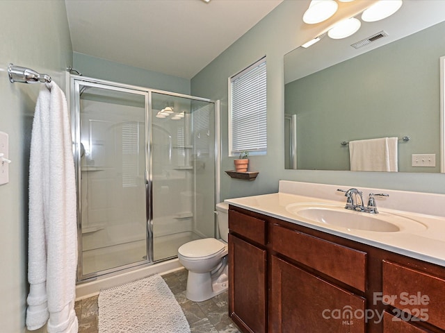 bathroom featuring visible vents, toilet, a stall shower, and vanity