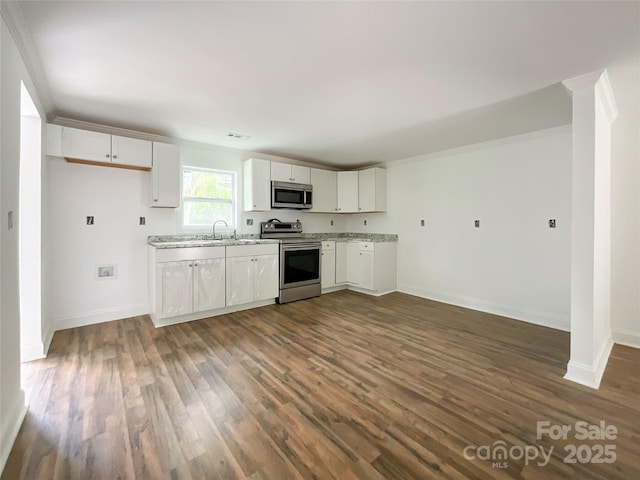 kitchen featuring dark wood-style floors, white cabinetry, baseboards, and appliances with stainless steel finishes