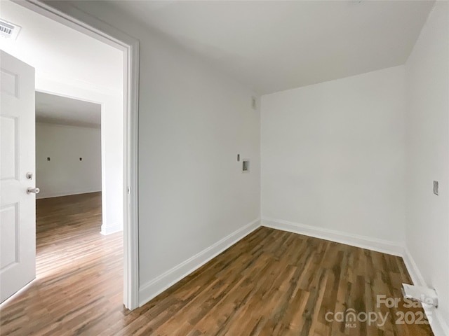 empty room featuring baseboards and wood finished floors