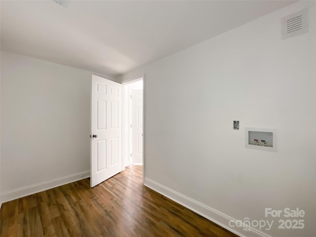 unfurnished room featuring dark wood-style floors, baseboards, and visible vents