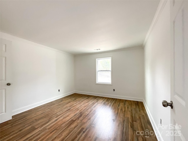 unfurnished room featuring crown molding, visible vents, baseboards, and dark wood-type flooring