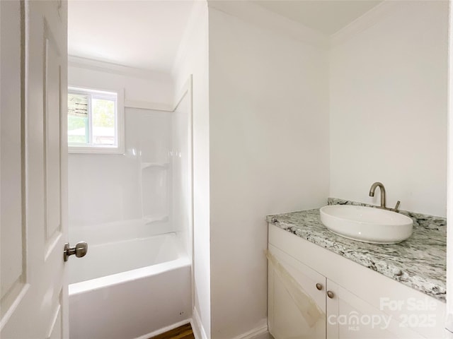 bathroom featuring washtub / shower combination and vanity
