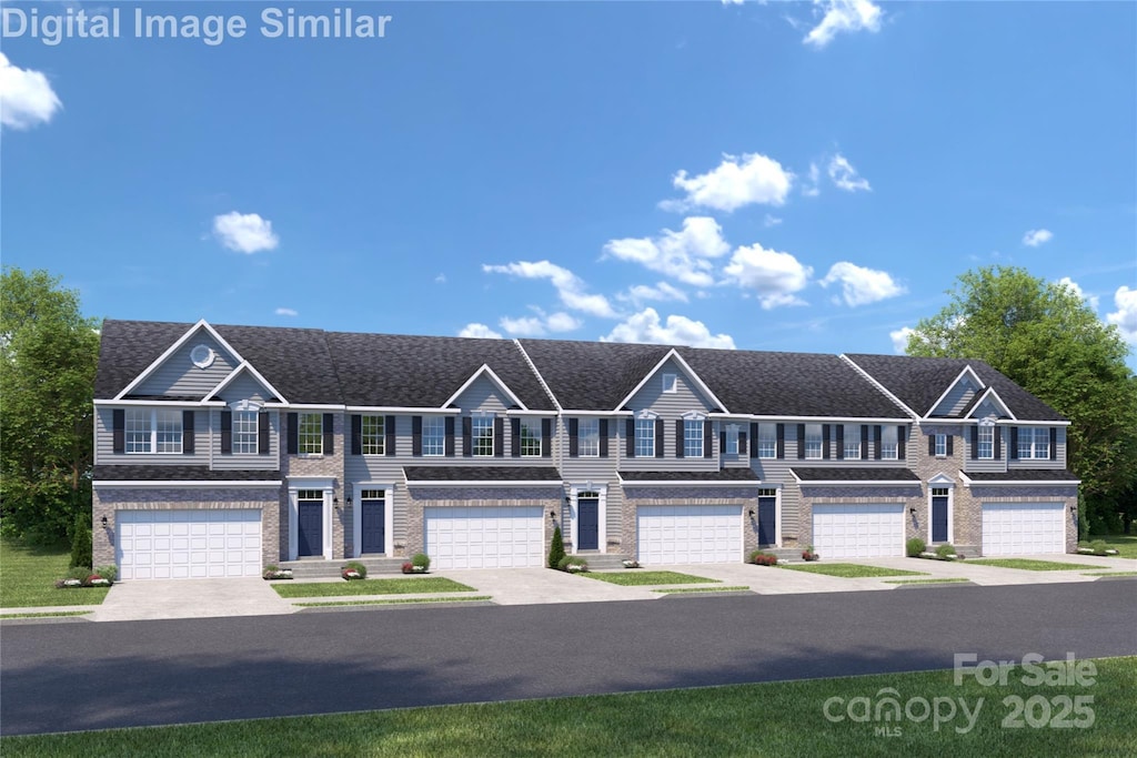 view of front of home featuring concrete driveway, roof with shingles, and a garage