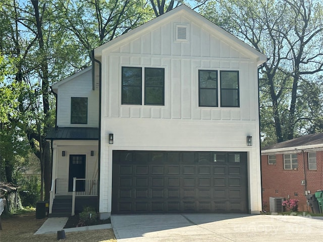 1413 Hateras Ave, Charlotte, NC 28216 - view of front of property with driveway, metal roof, board and batten siding, and a garage