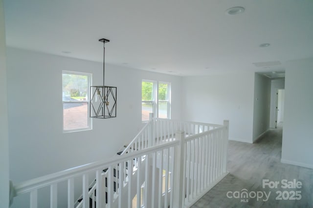 1413 Hateras Ave, Charlotte, NC 28216 - corridor featuring baseboards, an upstairs landing, and light wood-style flooring